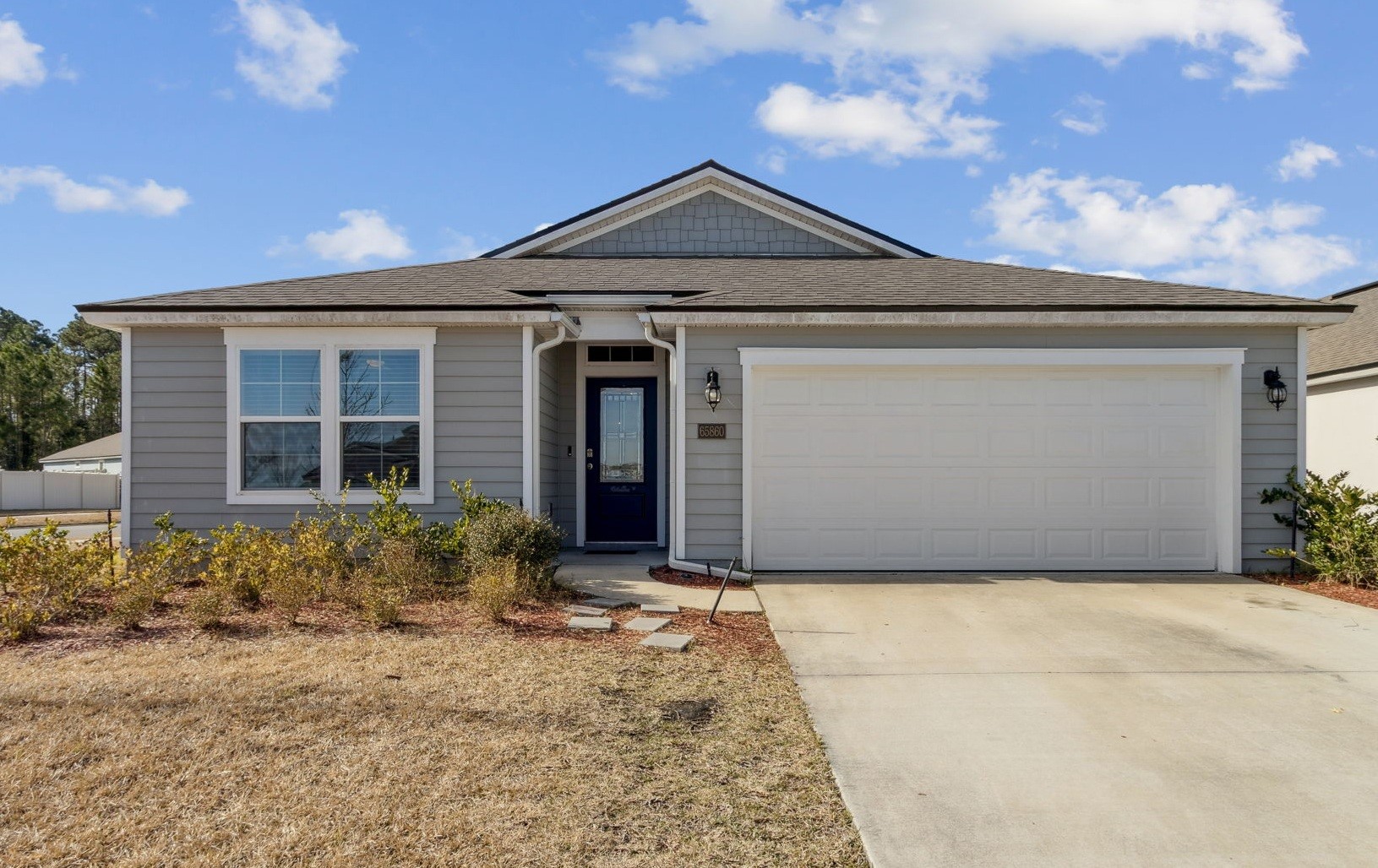 Front elevation of 65860 Edgewater Drive with two-car garage